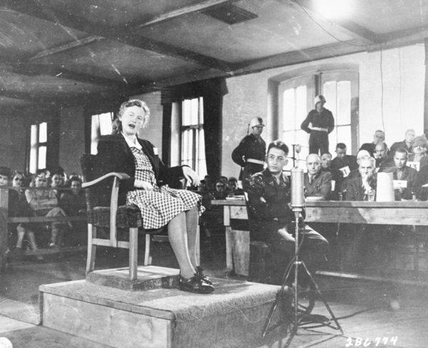 Ilse Koch testifying in her own defense at the KZ Buchenwald trial of former camp personnel. Photo by anonymous (8 July 1947). United States Holocaust Memorial Museum, courtesy of the National Archives and Records Administration, College Park. Wikimedia Commons.