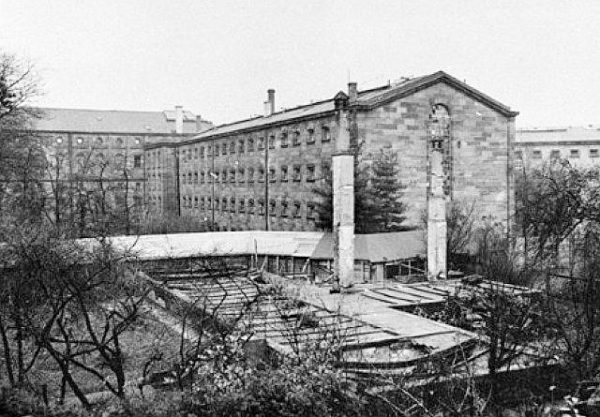 Exterior view of Nuremberg prison and the wing that housed Nazi war criminals during the Nuremberg trial. Note the covered walkway (white) leading from the prison wing to the Palace of Justice and courtroom. Prisoners walked through the covered path to and from the daily court proceedings. This wing was destroyed. Photo by anonymous (c. 1946).