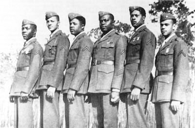 These are the first Marines to enter recruit training as instructors: Gilbert H. “Hashmark” Johnson (third from right) and Edgar R. Huff (second from right). Photo by anonymous. (date unknown).