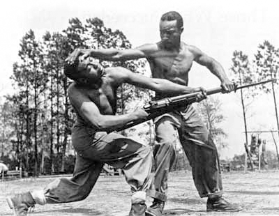 During a demonstration while training at Montford Point, Cpl. Arvin “Tony” Ghazlo, instructor in unarmed combat, disarms his assistant, PFC Ernest Jones. Photo by anonymous (date unknown). National Archives Photo 127-N-5334. 