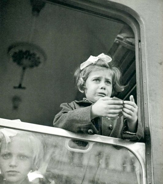 Leaving home and her parents. Notice the little girl in the lower left. Photo by anonymous (c. 1938-39).