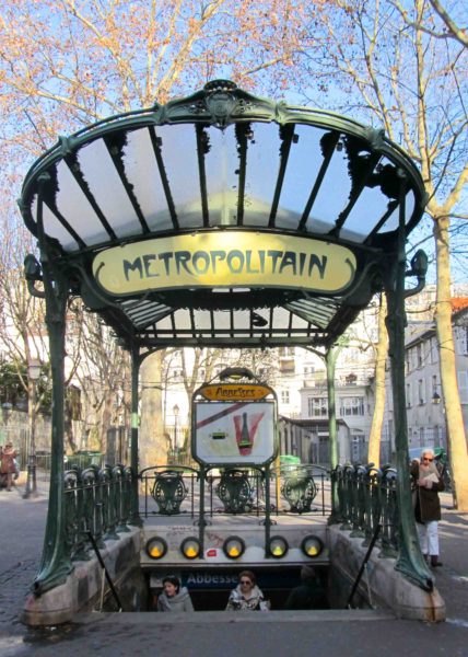 Entrance to the Abbesses métro station. Édicule design style A⏤this entrance once stood at the Hôtel de Ville métro station. It was relocated in 1974. Photo by Iste Pretor (4 January 2012). PD-GNU Free Documentation License. Wikimedia Commons.