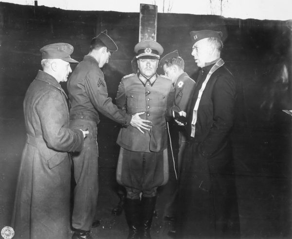 Anton Dostler is tied to a stake before his execution by a firing squad in the Aversa (Italy) stockade. Photo by anonymous (1 December 1945). PD- U.S. Government. Wikimedia Commons.