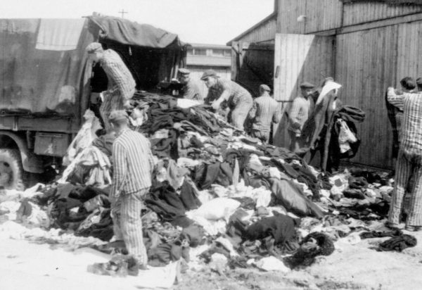 Clothing confiscated from new arrivals in the so-called “Canada” section of KZ Auschwitz II-Birkenau. Photo likely by E. Hoffmann or B. Walter (c. May 1944). PD-No copyright. Wikimedia Commons.