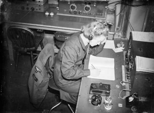 A WAAF (Women’s Auxiliary Air Force) wireless operator at work, receiving a message in morse code. Photo by Royal Air Force (date unknown). Imperial War Museum. PD-No copyright exists. Wikimedia Commons.