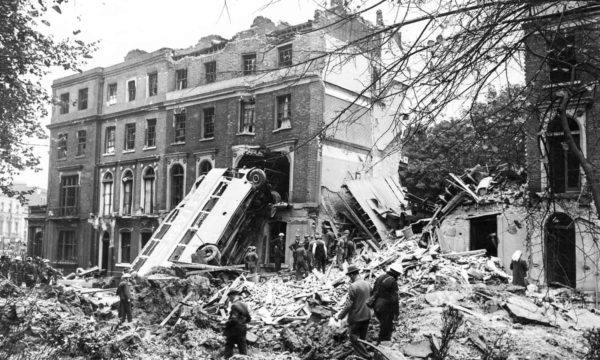 A bus is left leaning against the side of a terrace in Harrington Square, Mornington Crescent, in the aftermath of a German bombing raid on London during the first days of the Blitz. Photo by H.F. Davis (9 September 1940). Hulton Archive. PD-U.K. Government. Wikimedia Commons.