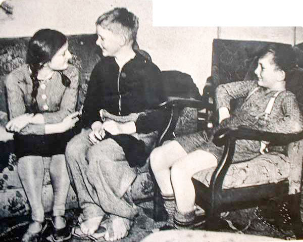 Three survivors: Sonia Bech (left), Colin R. Richardson (center), and Derek Bech (right). Photo by anonymous (c. September 1940). 