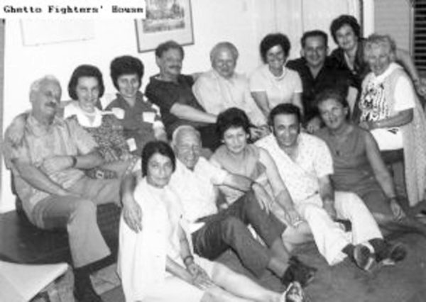 A meeting of former Warsaw ghetto resistance fighters. Zivia Lubetkin-Zuckerman (sitting, front row, far left), Yitzhak Zuckerman (upper row, fourth from the left), Vladka Meed (upper row, second from left). Photo by anonymous (c. 1973). Courtesy of the Ghetto Fighters’ House Museum. Catalog No. 21214.
