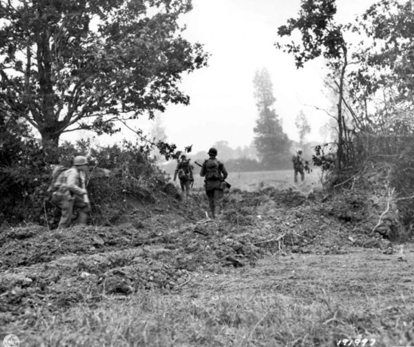 View of hedgerow after the breach by American tanks. Photo by anonymous (c. July 1944). Archives de la Mache, Saint-Lô. PD-U.S. Government. Wikimedia Commons.