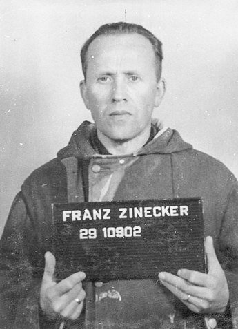 Mug shot of Franz Zinecker (1900−?), a defendant in the Dachau Trials. A former SS-Obersturmführer, Zinecker was sentenced to life imprisonment. He was released in the mid-1950s. Photo by anonymous (April 1947). PD-U.S. Government. Wikimedia Commons.