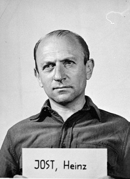 Mug shot Heinz Jost, a defendant in the Einsatzgruppen Trial (Case 9). Jost, former SS commander of Einsatzgruppe A, was convicted of crimes against humanity and sentenced to life imprisonment. He was released in 1951. Photo by anonymous (c. 1947). PD-U.S. Government. Wikimedia Commons. 