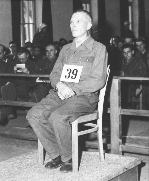 Otto Schulz (1903−?), former SS-Untersturmführer, testifying at his trial during the Dachau/Buchenwald trials. Schulz was found guilty of crimes against humanity and sentenced to death. He was released in 1953. Photo by anonymous (November 1945). PD-U.S. Government. Wikimedia Commons.