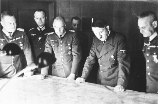 Hitler meeting with some of his generals. Gen. Franz Halder is on the far right. Photo by anonymous (c. 1940). Bundesarchiv Bild 146-1971-070-61/CC-BY-SA 3.0. PD-CCA-Share Alike 3.0 Germany. Wikimedia Commons.