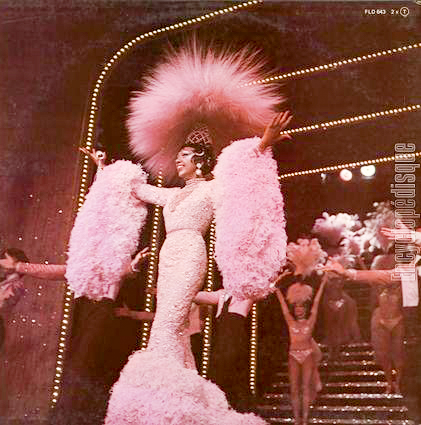 Josephine Baker performing at the Bobino club for the 50th anniversary of her first performance in Paris. Four days later, Josephine passed away from a cerebral hemorrhage while reading her reviews. Photo by anonymous (8 April 1975). www.encyclopedisque.fr.