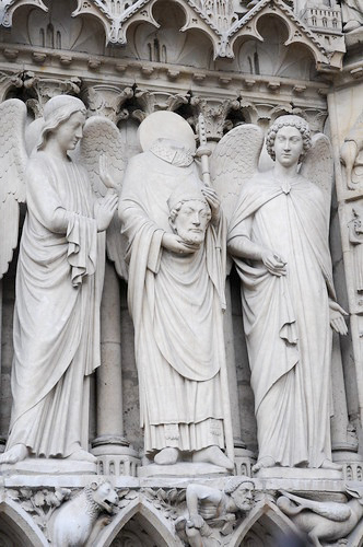 Statues of biblical and religious figures located on the exterior of Notre-Dame. The middle statue is Saint Denis. Photo by Dan Owen (c. 2013). Courtesy of Dan Owen.