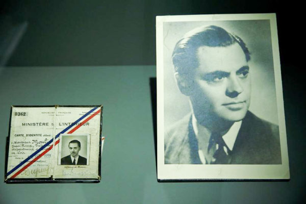 Portrait of Jean Moulin (right) and his French identification card (left) on display at the Paris Liberation Museum. Photo by anonymous (date unknown). Reuters. 