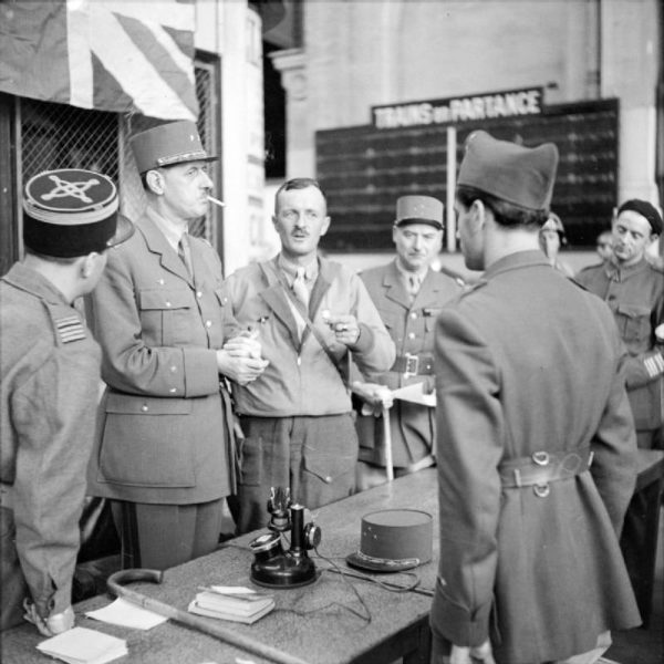 Shortly after Gen. Charles de Gaulle (second from left) arrived in Paris following the city’s liberation, he met with senior members of the Free French and resistance fighters. He was furious that Gen. Leclerc (third from left) had allowed the Communist resistance leader, Col. Henri Rol-Tanguy (far left), to sign the surrender document. Photo by Capt. E.G. Malindine (25 August 1944). PD-Released by the Imperial War Museum. Wikimedia Commons.