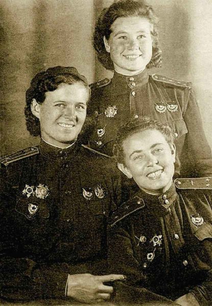 Officers of the 588th. Evdokia Bershanskaya (left), Maria Smirnova (standing), and Polina Gelman (right). Photo by anonymous (c. 1944). PD-CCA-4.0 International. Wikimedia Commons. 