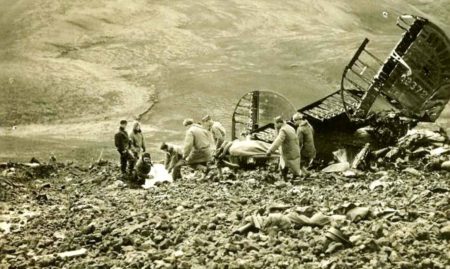 U.S. Army personnel remove bodies from the wreckage of Andrew’s B-24 after an aborted landing at RAF Kaldadarnes, Iceland. Photo by anonymous (3 May1943). PD-U.S. Government. Wikimedia Commons.