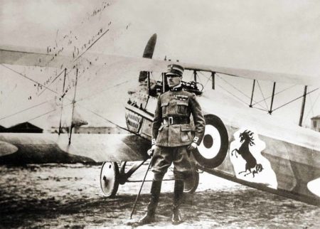 Count Francesco Baracca and his SPAD S.VII. Notice the “Prancing Pony” as his nose art. This artwork was adopted by Enzo Ferrari as the logo for his race cars and automobile company. Photo by anonymous (c. 1918). PD-No copyright. Wikimedia Commons.