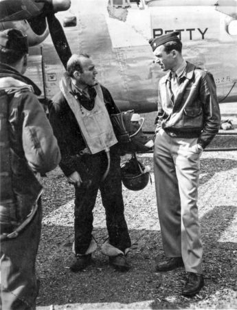 Maj. James Stewart confers with a B-24 crew member. Photo by anonymous (c. 1943). PD-U.S. Government. Wikimedia Commons.