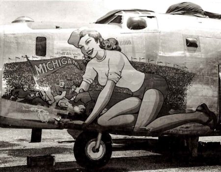 Nose art featured on B-24J known as “Michigan.” Created by Sarkis Bartigian, a prolific nose artist, this depicted Michigan stadium and a cheerleader. The pilot must have attended the University of Michigan. Go Blue! Photo by anonymous (date unknown). War Birds News.
