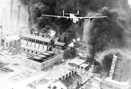 A B-24 flying over a burning refinery at Ploesti, Romania during Operation Tidal Wave. Photo by anonymous (1 August 1943). PD-U.S. Government. Wikimedia Commons.