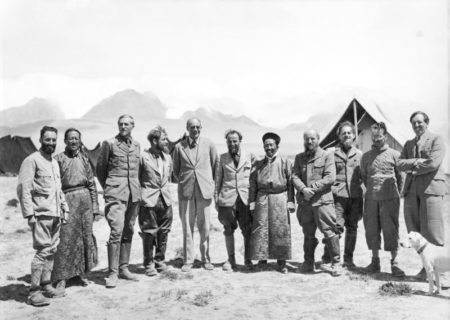 Members of Tibet expedition with Tibetans. Standing from left to right: Beger (third), Schäfer (fourth), Sir Basil Gould (fifth), Krause (sixth), Wienert (eighth), and Geer (tenth). Himalayan mountains are in the background. Photo by anonymous (c. 1938/39). Bundesarchiv, Bild 135-KA-11-008/CC-BY-SA 3.0. PD-CCA-Share Alike 3.0 Germany. Wikimedia Commons. 