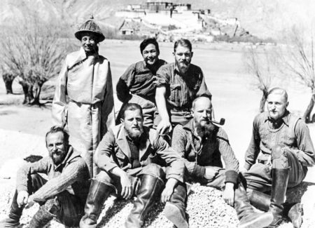 Members of Tibet expeditionn with Tibetans. Sitting from left to right: Krause, Geer, Wienert, and Beger. Second row, far right: Schäfer. Tibet palace is in the background. Photo by anonymous (c. 1938/39). Bundesarchiv, Bild 135-KA-10-063/Krause, Ernst/CC-BY-SA 3.0. PD-CCA-Share Alike 3.0 Germany. Wikimedia Commons. 