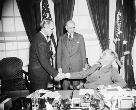 Joe Kennedy being congratulated upon his appointment as ambassador to the Court of St. James by President Franklin D. Roosevelt. Photo by anonymous (c. 1938). 