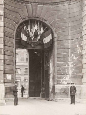 Entrance, or portal to Paris police headquarters immediately after liberation. The bullet holes are very noticeable in contrast to the darkened stone façade. Photo by anonymous (c. August 1944). PWVB Images/Alamy Stock Photo.