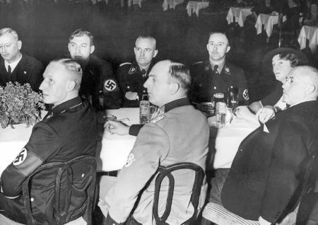 Reich Ministry of the Interior meeting. Reinhard Heydrich (front row, left), Wilhelm Stuckart (back row, opposite Heydrich), and Heinrich Himmler (back row, two seats from Stuckart). Photo by anonymous (c. 1937). SV-Bilderdienst, 00028000. 