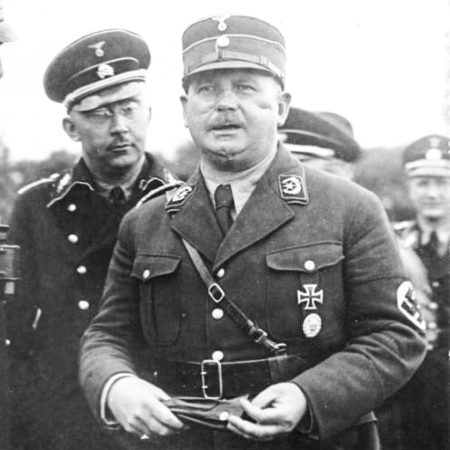 Heinrich Himmler (left) and Ernst Röhm (right). Röhm was the leader of the Sturmabteilung, or “Brown Shirts.” Both uniforms were supplied to Hitler by Hugo Boss and his company. Photo by anonymous (c. 1933). Bundesarchiv, Bild 102-14886/CC-BY-SA. PD-.CCA-Share Alike 3.0 Germany. Wikimedia Commons. 