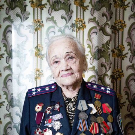Olha Tverdokhilbova, 98, at her home in Vinnytsia, Ukraine. A Soviet sniper during World War II, Olha recently offered her services as a skilled sharpshooter to the Ukrainian Resistance. Photo by Emanuele Satolli for The Wall Street Journal (May 2022). 