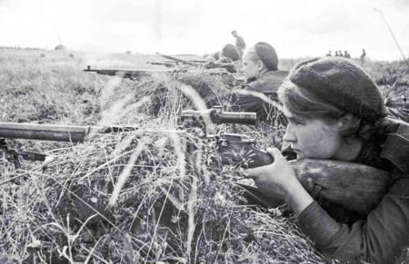 Soviet sniper, Sgt. Lyuba Makarova (foreground) and other female snipers peer through their rifle scoops. This is likely taken during a training session. Makarova was credited with 84 kills. Photo by anonymous (date unknown). 