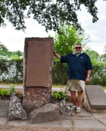 Stew is standing next to the Strasbourg memorial dedicated to the murdered members of réseau Alliance. Photo by Sandy Ross (6 June 2022).