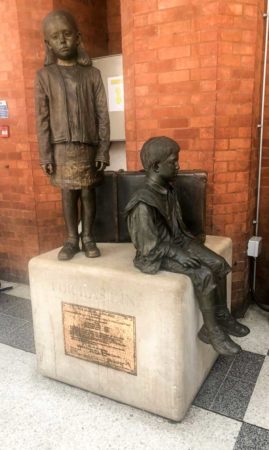 Inside Liverpool Street Station. One of the three bronze statues memorializing the Kindertransport. The statue is “Für das Kind”, or “For the Children". It was dedicated in September 2033 and re-dedicated in May 2011 by Sir Nicholas Winton. It was sculpted by Flor Kent. Photo by Sandy Ross (15 June 2022).