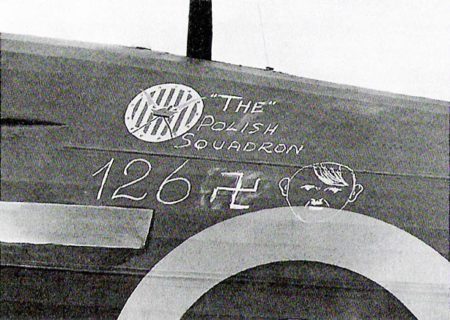 Artwork on the side of a fighter plane from the No. 303 Squadron (“The Polish Squadron”) during the Battle of Britain. Piloted by a Polish pilot, the artwork commemorates the 126 “Adolfs” shot down by the 303rd. Photo by anonymous (c. 1940). PD-Poland public domain. Wikimedia Commons.