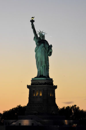 Statue of Liberty at dusk taken from the deck of the ms Rotterdam leaving New York City Harbor. Photo by Sandy Ross (27 October 2022). 