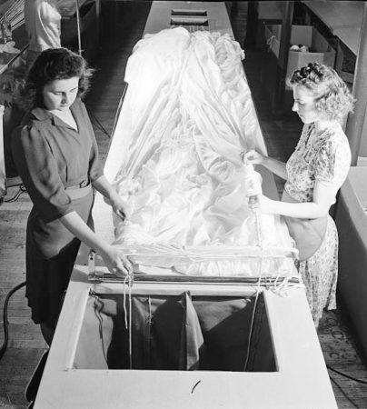 Two women inspect a parachute during World War II at the Pioneer Parachute Company, Manchester, CT. Photo by anonymous (date unknown). 