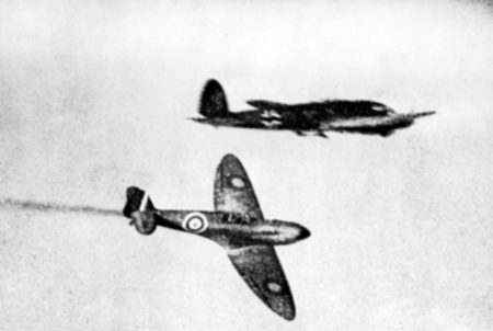 A RAF Supermarine Spitfire trails smoke after attacking a German Heinkel He 111H/P bomber during the Battle of Britain. Photo by anonymous (c. 1940). PD-Expired copyright. Wikimedia Commons.