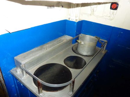 The galley on the U-995. Food was stored in the reserve toilet-so it was unusable at first. Photo by James Steakley (7 August 2012). PD-CCA-Share Alike 3.0 Unported. Wikimedia Commons.