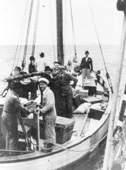 Danish fishermen (foreground) ferry Jews across a narrow sound to safety in neutral Sweden during the German occupation of Denmark. Photo by anonymous (c. 1943). U.S. Holocaust Memorial Museum.