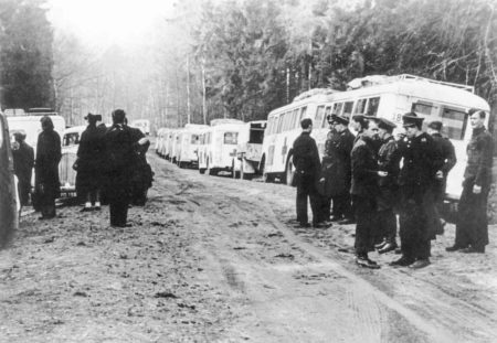 Danish police next to a convoy of Red Cross White Buses parked alongside the road. The first bus on the right is the #38 bus. This bus is currently on display at Yad Vashem, Jerusalem. Photo by anonymous (c. April 1945).