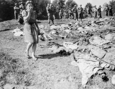 A German woman is overcome as she walks past the exhumed bodies of 800 slave workers murdered by SS guards near Namering, Germany. 