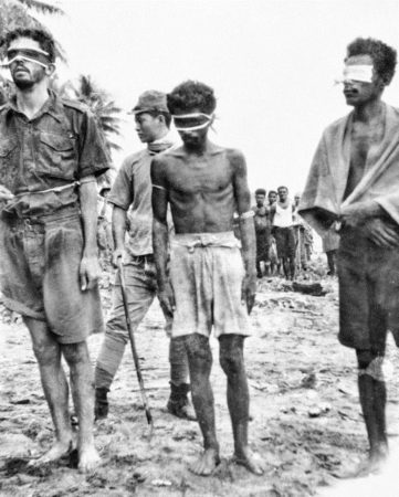 Sgt. Leonard Siffleet (left), Pvt. Pattiwahl (center), and Pvt. Reharin (right) standing blindfolded before their executions by the Japanese. The men were on a reconnaissance mission behind enemy lines. This photo was found on the body of a dead Japanese soldier. 