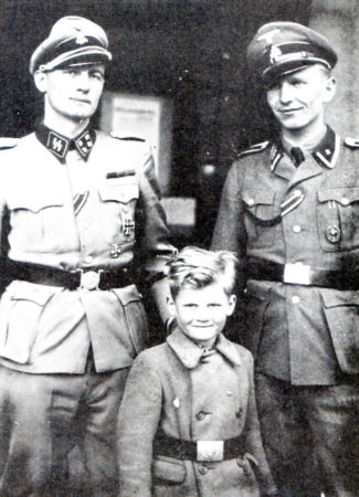 SS-Hauptsturmführer Christian Frederik von Schalburg (left), his son Alex (center), and SS-Unterscharführer Søren Kam. Photo by anonymous (c. September 1940). PD-Published outside the United States, published before 1 March 1989, and in the public domain of home country. Wikimedia Commons. 
