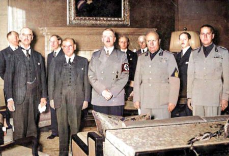 Colorized image of the Munich Conference. Right to left: Gian Galeazzo Ciano, Benito Mussolini, Hitler, Edouard Daladier (France), and Neville Chamberlain (U.K.). Colorized photo by Mareček2000 (c. 2020). PD-CCA-Share Alike 4.0 International. Wikimedia Commons. 