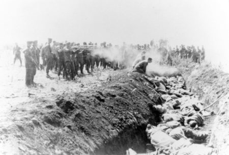 Execution by SS Einsatzgruppen of Soviet civilians kneeling by the side of a mass grave