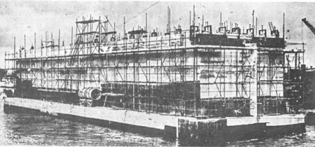 Construction of concrete caisson nearing completion in the London docks. Photo by anonymous (c. 1944). 